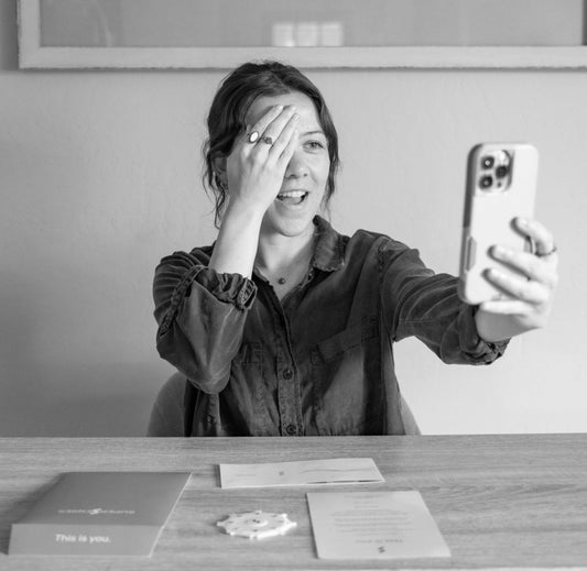 Woman using sensory testing card to measure smell function, illustrating sensory health awareness.
