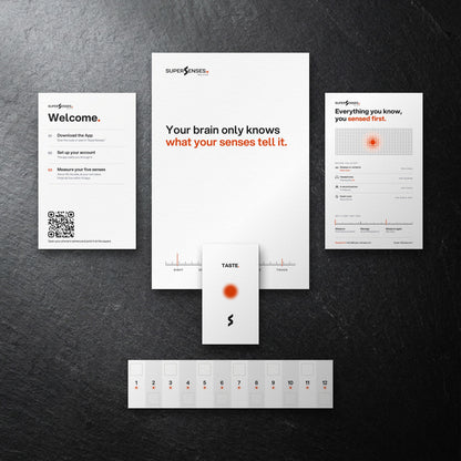 SuperSenses Five Senses Kit welcome card, envelope and test pieces on a slate background